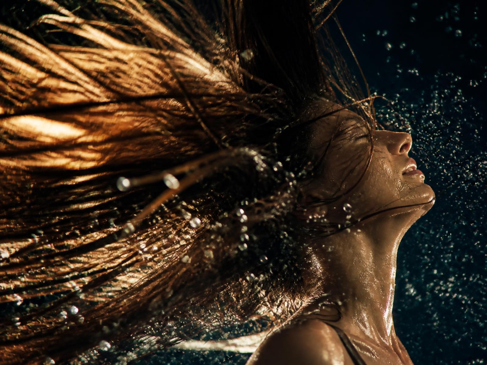 Healthy hair in motion with sunlight and water