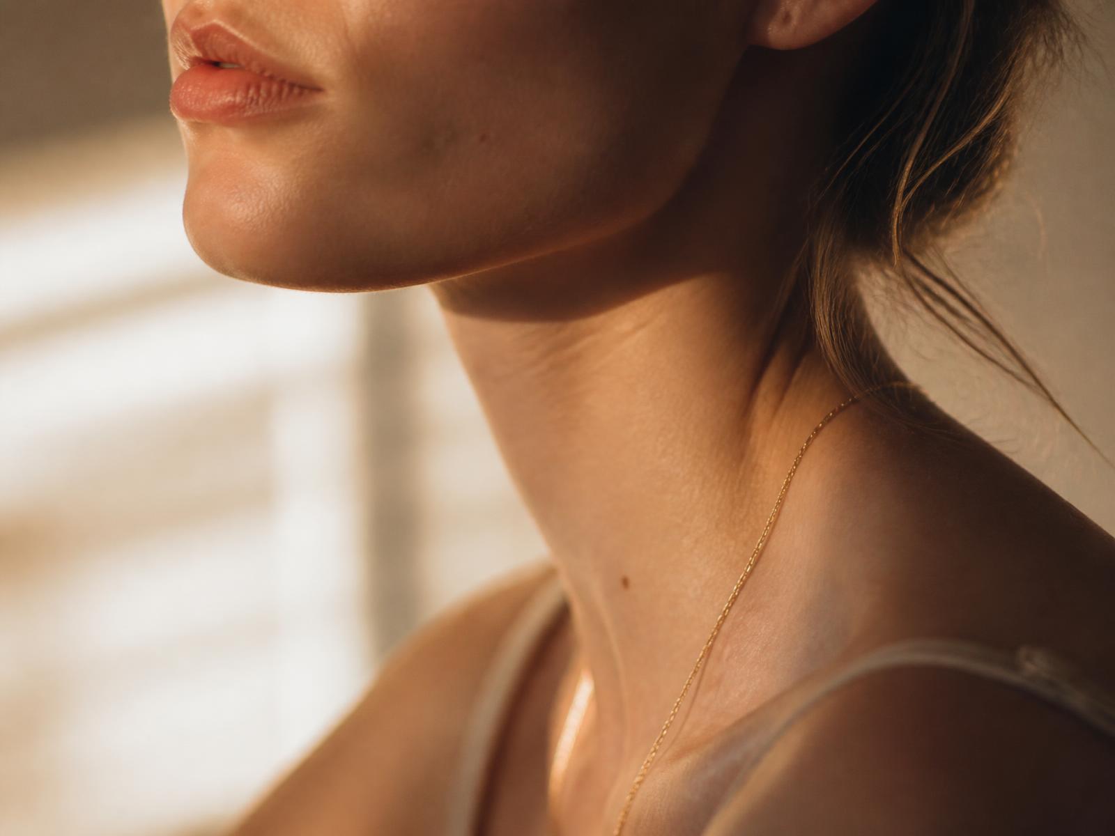 Close crop of natural skin in soft window light